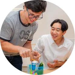 Two colleagues building something at a table