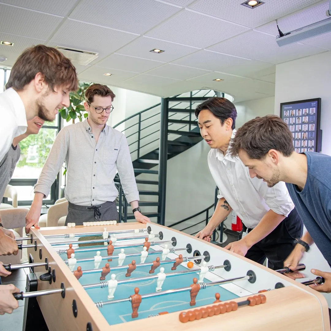 Colleagues playing table football