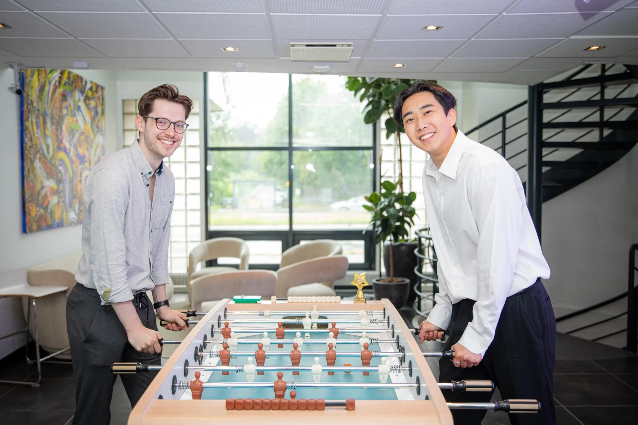 Colleagues playing table football