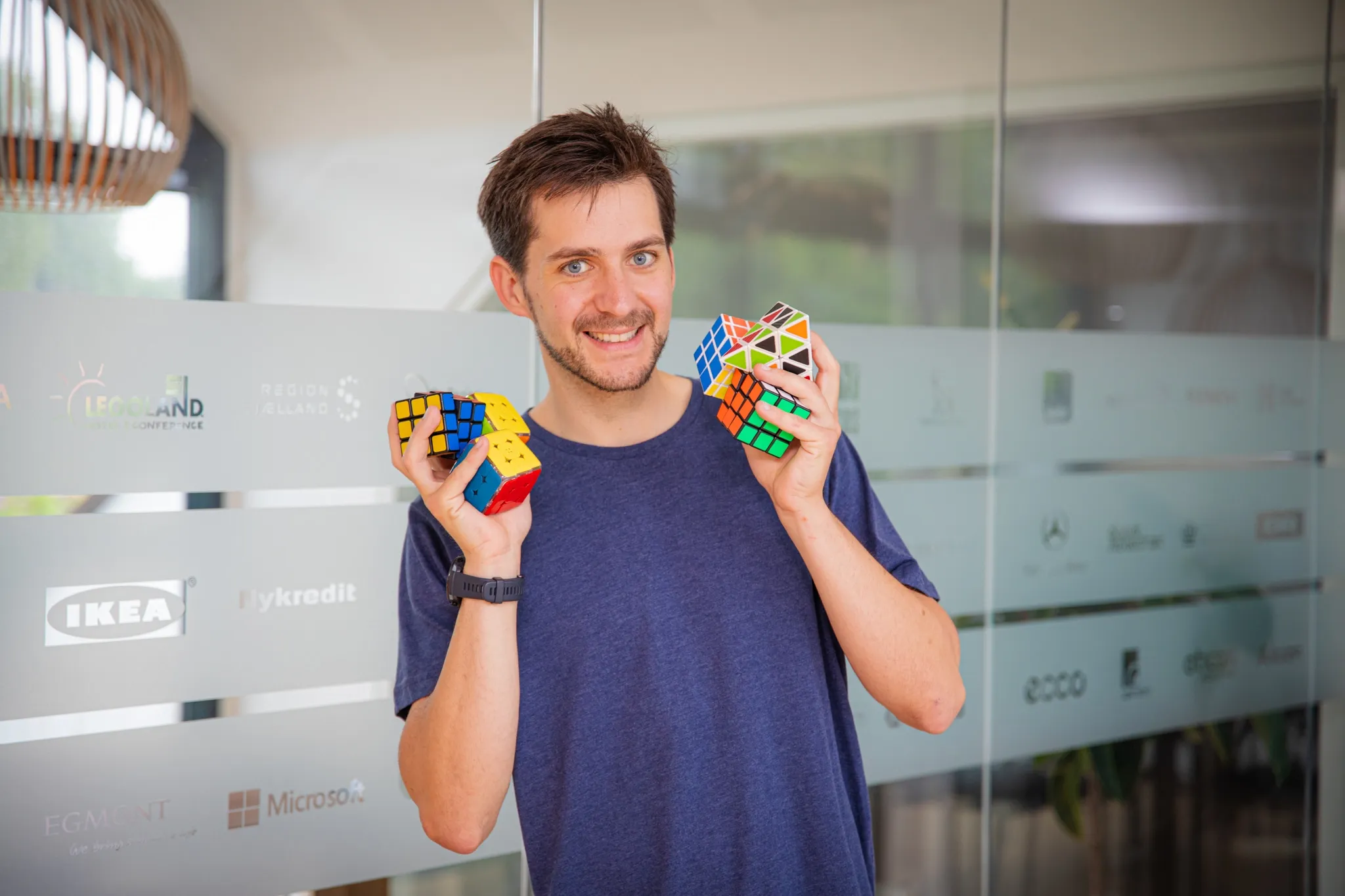 Moritz holding up two Rubik’s cubes