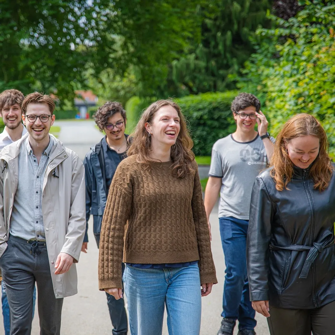 The team walking outside, laughing